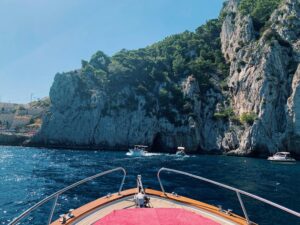 A scenic boat ride on the Amalfi Coast, showcasing majestic cliffs and the azure sea.